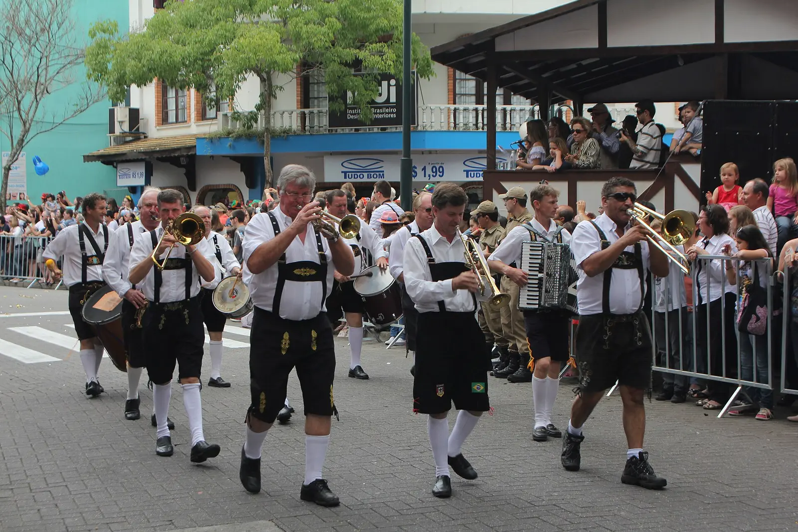 A Bavarian brass band in lederhosen marching through the Oktoberfest parade in Blumenau