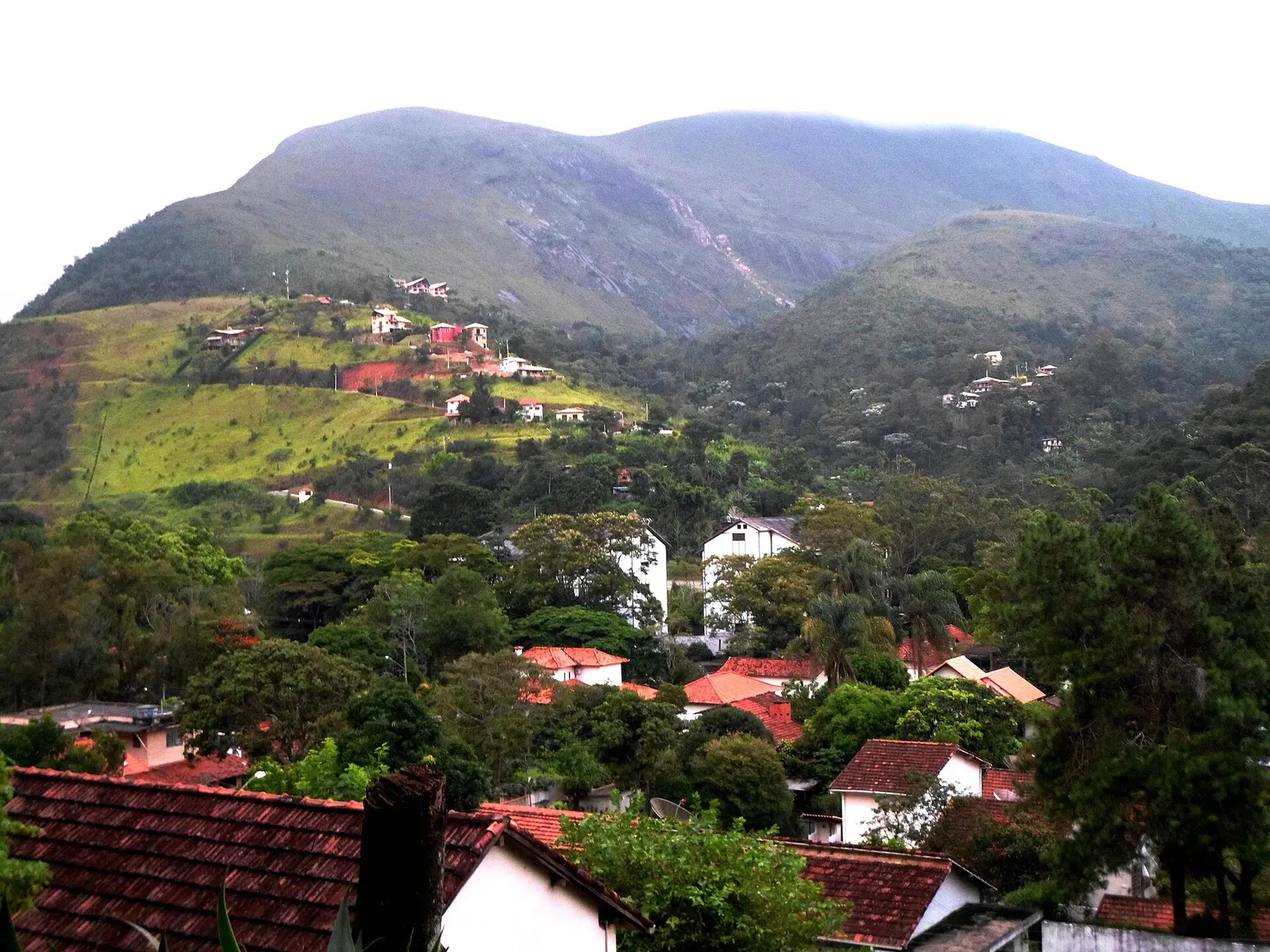 Red-roofed houses on green mountain slopes in Itaipava, Petrópolis